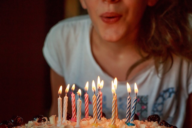 A child blowing out birthday candles.
