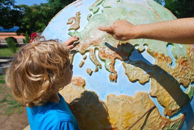 One of our male students learning where places are on a globe.