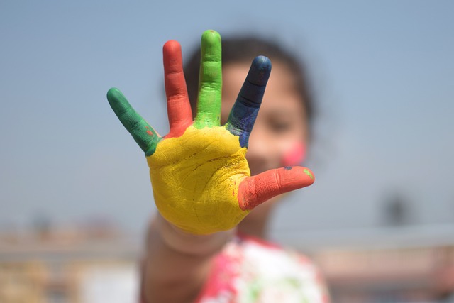 One of our students showing us thier colorful hand after arts and crafts.