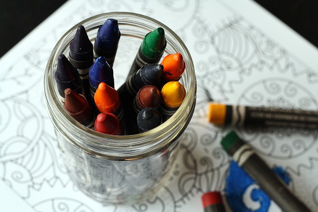 crayons on top of a coloring book.