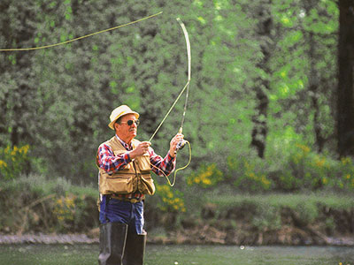 A picture of a man fly fishing.