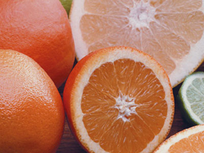 A photo of oranges and limes sliced in half.